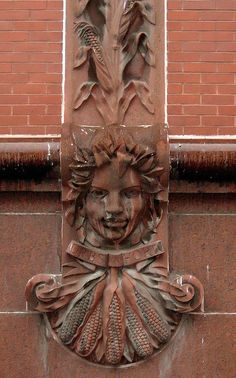 a decorative face on the side of a building