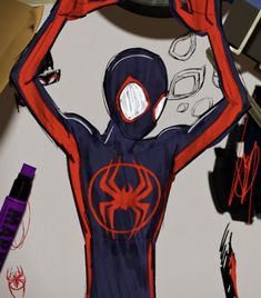 a drawing of a spider man holding his hands up in the air with other objects around him