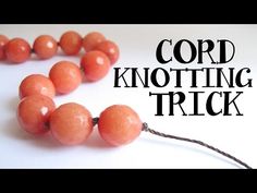 an orange bead necklace with the words knotting against a bead