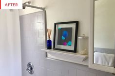 a bathroom with white tile and blue vases on the shelf next to the shower