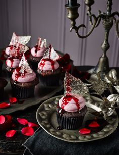 cupcakes with pink frosting and red sprinkles on a plate