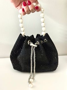 Length: 5.91 inches, Height: 5.71 inches This beautiful black bag is perfect for fancy dinner, date nights or as a gift to a friend. It can be carried as a hand bag or a crossbody. It comes with a detachable chain strap. The pearl handle and rhinestone studs make this a statement bag  evening pearl bag evening bag sequin evening bag evening clutch purse black clutch  evening bag black purse black bag evening stylish clutch affordable holiday gift black rhinestone bag  black rhinestone purse wedding purse bridal bag  bridesmaid purse Luxury Versatile Evening Bag With Detachable Strap, Evening Bucket Bag With Rhinestones, Evening Bucket Bags With Rhinestones, Luxury Handheld Bucket Bag For Party, Elegant Bucket Evening Bag For Wedding, Elegant Wedding Bucket Evening Bag, Black Rectangular Bucket Bag For Party, Elegant Bucket Bag With Rhinestones, Elegant Rhinestone Bucket Bag