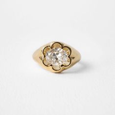 a gold ring with a diamond in the center