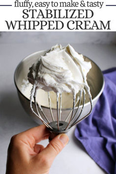 a hand holding a whisk with whipped cream in it and the words, fluffy, easy to make & tasty