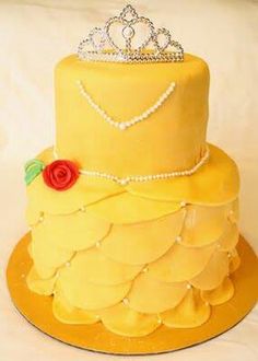 a yellow cake with a tiara on top and pearls around the edges, sitting on an instagram page