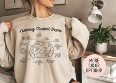 This Nursing Student Brain  Crewneck Sweatshirt is the perfect birthday gift, graduation gift, or Christmas gift for all Nursing Student! All of our shirts are made with the highest quality materials and are super soft and cozy! 💚 HOW TO ORDER 💚 1. Check our photos for sizing and color options. 📏 2. Choose your quantity.  Feel free to add as many shirts as you wish! ✨ 3. Select your size and color from the drop-down menus. ✨ 4. Click "ADD TO CART" to add the shirt to your virtual cart. 🛒 5. Click "PROCEED TO CHECKOUT" to purchase your shirt. 🛒 6. Your shirt is now off to production!  We will process your order and your shirt will be ready for shipment in 1-4 days! 🎁 📏 SHIRT SIZING All of our shirts come in a variety of colors and many different sizes! ✨ SHIRT INFORMATION + MATERIAL Casual Crew Neck T-shirt For Graduation Gift, Casual Crew Neck Top For Graduation Gift, Nurse Sweater, Nurse Student, Nurse Graduation Gift, Gift For Nurse, Nursing Graduation, Nursing Student, Gift Graduation