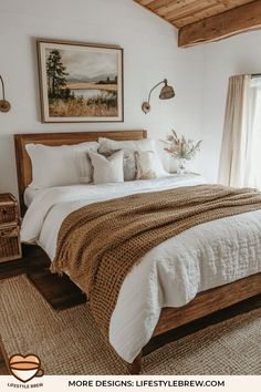 a bedroom with white walls and wooden ceilinging, large bed covered in blankets and throw pillows