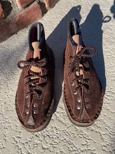 A unique pair of women's size 6.5 vintage mountaineer style boots.  Handmade boots feature brown suede, leather toe , comfy squishy footbed,  the thick rubber sole is flexible. The Silver utilitarian rivets add a quirky boho feel and nail detail are killer. These boots are really everything. Suede Lace-up Work Boots For Hiking, Brown Lace-up Boots With Reinforced Toe For Adventure, Brown Lace-up Boots For Hiking, Brown High-top Adventure Work Boots, High-top Brown Work Boots For Adventure, Brown Lace-up Hiking Boots With Vibram Sole, Brown High-top Work Boots For Adventure, Brown Lace-up Boots With Vibram Sole, Brown Ankle Hiking Boots For Adventure