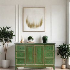 a green cabinet with two potted plants on top and a painting in the background