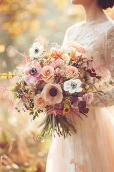 a woman holding a bouquet of flowers in her hands