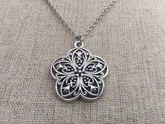 Chic and pretty boho flower pendant necklace. It has incredible detail and is very versatile.  The perfect everyday necklace!  It would also make a sweet little gift.The pendant measures 1 1/8” long by 1” wide and hangs from a simple stainless steel necklace chain with a lobster clasp.I have matching earrings in my shop, if you would like the whole set.  Here is the link........... https://etsy.me/35eCXaU Thanks for stopping by!  Please take a moment and visit the rest of my Etsy shop.  I have m Silver Flower Jewelry For Festival, Bohemian Flower Jewelry For Festivals, Bohemian Flower Shaped Jewelry As A Gift, Bohemian Necklace With Flower Charm For Festival, Bohemian Style Flower Charm Necklace As Gift, Bohemian Flower Charm Necklace As A Gift, Bohemian Necklace With Flower Pendant As Gift, Bohemian Necklace With Flower Charm For Gifts, Bohemian Flower Pendant Necklace As Gift