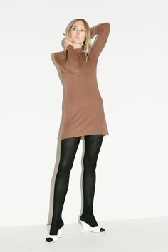 Really soft mini dress in a micro ribbed knit with mockneck and long sleeves. Cute as a dress or longer profile top. Tencel fabric is made from wood fibers and is compostable and biodegradable. Fabric is 100% tencel lyocell. Ella is 6' tall, 36" bust, 27.5" waist, 38" hip, and is wearing a size S/M Winter Workwear Long Sleeve Stretch Dress, Stretch Ribbed High Neck Sweater Dress, Stretch Ribbed Brown Sweater Dress, Brown Ribbed Stretch Sweater Dress, Brown Stretch Ribbed Sweater Dress, Stretch Ribbed Turtleneck Mini Dress, Stretch Ribbed Turtleneck Sweater Dress, Ribbed Turtleneck Mini Dress For Fall, Winter High Neck Stretch Long Sleeve Dress