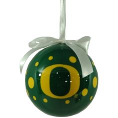 a green and yellow ornament with the letter o on it