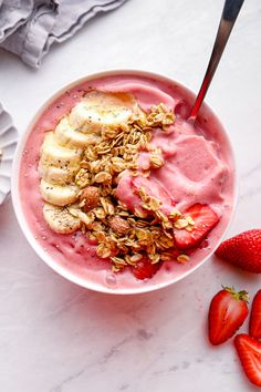 a bowl of yogurt with strawberries and granola on top, text overlay reads spoon the smoothie into the bowl & add toppings