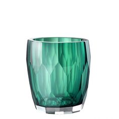 a green glass vase sitting on top of a table