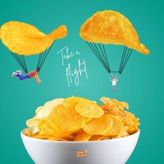 a bowl filled with potato chips and two parachutes above it that say take a flight