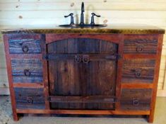 a bathroom vanity made out of wood with a sink and faucet on top