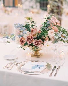 an elegant table setting with pink and blue flowers