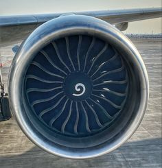 an airplane engine on the tarmac with it's turbine visible