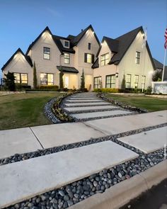 a large house with steps leading up to the front door and side yard at night