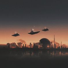 four star trek ships flying over a city at sunset