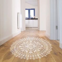 a hallway with wooden floors and an ornate rug on the floor in front of it