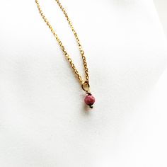 "This  necklace features tiny  Ruby bead. Minimalistic design ,  stylish for every occasion and everyday wear. Perfect looking , unique personal necklace wrapped for gift giving or as a wonderful present for you!  You can choose diffrent gemstones from drop down menu... ♡ DETAILS  Bead gemstone- 4 mm- 0.15\" Necklace length please choose... Material: gold plated 24 k over sterling silver 925 All gemstones are natural, they may vary slightly in color and size.  The jewelry is made entirely of 925 Pink Minimalist Birthstone Necklace, Pink Minimalist Necklace With Delicate Chain, Minimalist Pink Necklace For Everyday, Minimalist Pink Gold Necklace For Gift, Minimalist Pink Everyday Necklace, Dainty Charm Necklaces With Tiny Beads For Gift, Red Minimalist Birthstone Necklace, Minimalist Charm Necklaces With Tiny Beads For Gifts, Minimalist Tiny Beads Charm Necklace As Gift