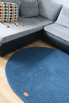 a blue rug is on the floor next to a couch