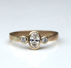 a gold ring with three diamonds on it