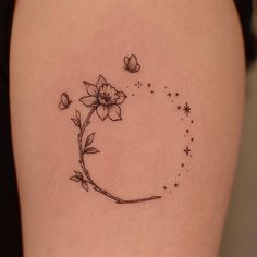 a woman's thigh with a flower and butterfly tattoo on the back of her leg