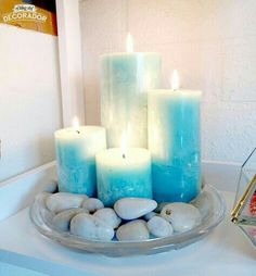 some rocks and candles are sitting on a tray