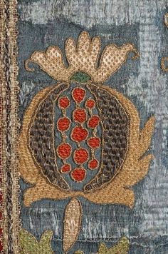 an old piece of cloth with flowers and leaves on the bottom, in blue tones