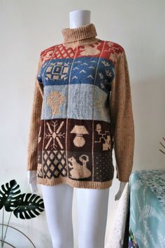 Beautiful True Vintage Stefanel knit sweater from the 1990s or early 2000s. Comfortable and soft wool blend in gorgeous mottled camel brown. Straight cut. Ribbed roll neck and sleeves. Multicolor grids on the front and on the back with different motives e.g. a squirrel, leaves, a lamp, a snowflake, a bird and geometric shapes. Made in Italy! Looks great combined with an (off-)white pair of jeans and brown square toe ankle boots! BRAND: Stefanel ERA: 1990s, 2000s COLOR: Mottled camel brown/sand, Vintage Beige Tops For Winter, Vintage Knit Sweater For Winter, Vintage Brown Tops For Winter, Vintage Brown Top For Winter, Vintage Wool Tops For Winter, 90s Style Long Sleeve Knitted Sweater, 90s Style Knit Sweater For Fall, 90s Style Knitted Tops For Winter, 90s Style Winter Knitted Tops