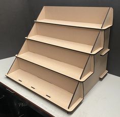 three cardboard shelves stacked on top of each other