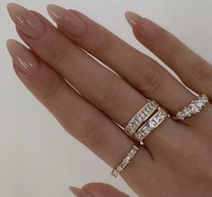 a woman's hand with two rings on it and one ring in the middle