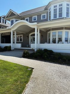 a large gray and white house with lots of windows