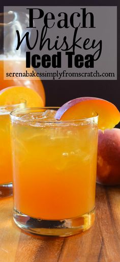 two glasses filled with peach whiskey on top of a wooden table