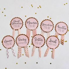 pink and gold baby shower cupcake toppers with name tags on them for guests to be