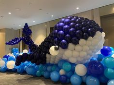 balloons are arranged in the shape of an octopus on display at a corporate office building