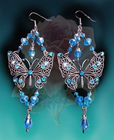 "These Handmade Sparkly Crystal Butterfly Chandelier Earrings are made with crystal beads and plated metal butterflies. Hand-set Swarovski rhinestones add an intense sparkle! ...truly magical! Available with French Wires, Posts or Clip-Ons. -5\" Long x 2\" Wide -0.4 oz. ea. -Many Colors Available in the pull-down menu!  Light Violet is seen in the video. Metal Finishes Available: -Antique Silver -Bronze -Antique Gold *Please note the color options are shown on a white background and are representations of the colors available.  I try my best to show them as close to the actual colors as possible but all monitors show colors differently.  If you are unclear on any of the colors and would liike additional pictures please ask before purchase! *Comes Ready To Gift in Decorative Packaging *Each Crystal Jeweled Chandelier Earrings Gift, Nickel-free Butterfly Jewelry For Party, Party Jewelry With Butterfly Dangle Charm, Blue Butterfly Charm Jewelry For Party, Butterfly-shaped Rhinestone Party Jewelry, Party Jewelry With Rhinestones And Butterfly Shape, Butterfly-shaped Party Jewelry With Rhinestones, Party Jewelry With Rhinestones In Butterfly Shape, Butterfly Shaped Party Jewelry With Rhinestones