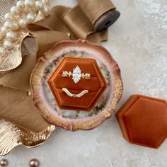 Our rich deep burnt orange ring box is perfect for fall weddings.  Highlight both wedding band and engagement ring with this double slotted ring box.  Style this ring box with our crepe mustard ribbon for the perfect flat lay.. RING BOX: ► Double Slotted  ► BURNT ORANGE  Velvet ► Hexagon shape  ► 1  7/8"  at widest point  x  1  ¾" tall  ** also available in ROUND & Triple slotted rectangle** 📷 Photos represent an example of the Ring Box & wax seals.  Please allow for color variations. Photography, lighting & computer monitors can affect color. 📷  Additional FLAT LAY KITS available:  https://www.etsy.com/shop/ChampagneAndGRITco?ref=search_shop_redirect&section_id=28629656 OTHER INFORMATION: ►Champagne & GRIT does NOT accept returns, each piece is hand made to order.  ►The photo is a repre Heirloom Style Orange Ring For Gift, Heirloom Orange Ring For Gift, Heirloom Orange Ring As Gift, Orange Ring, Orange Velvet, Hexagon Shape, Ring Box, Burnt Orange, Natural Materials