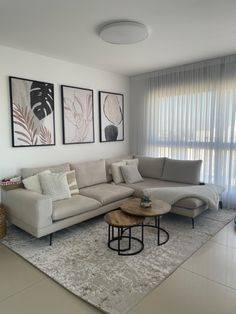 a living room filled with furniture and pictures on the wall above it's windows