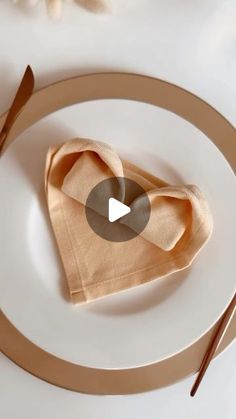 a white plate topped with a napkin and fork