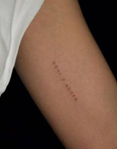 a woman's arm with the word love written in cursive writing on it