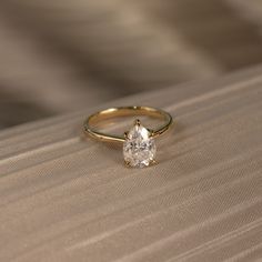 a diamond ring sitting on top of a table