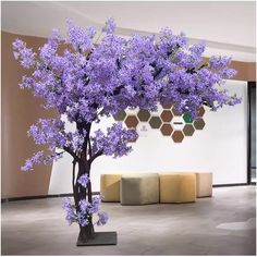 a purple tree in front of a white wall with honeycombs on the walls