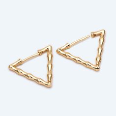 High quality 18K gold plated brass hoop earring hooks, color not easily tarnish, lead nickel safe Size: triangle side length 25mm approx. (see Pic 2) Quantity: 4pcs= 2 pairs Color: gold ❤ More gold plated brass items here: ❤ https://www.etsy.com/shop/Nbeads?search_query=GB ❤ More metal findings(brass, silver, alloy etc.) here: ❤ https://www.etsy.com/shop/Nbeads?section_id=6656259 Triangle Gold Metal Earrings, Gold Triangle Metal Earrings, Modern Triangle Gold Hoop Earrings, Everyday Gold Triangle Earrings, Gold Triangle Jewelry With Ear Wire, Brass Items, Brass Hoop Earrings, Gold Triangle, Brass Hoops