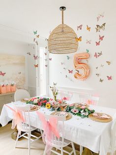 the table is set with pink and gold decorations