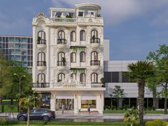 a large white building with lots of windows and balconies on the top floor