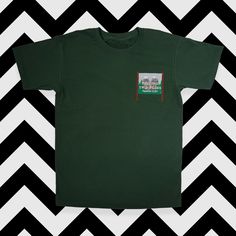 'Welcome to Twin Peaks' sign embroidered onto a high quality cotton t-shirt. Graphic Tee With Embroidered Logo, Green Cotton Tops With Embroidered Logo, Green Cotton Top With Embroidered Logo, Casual Green T-shirt With Embroidered Logo, Cotton T-shirt With Embroidered Graphics, Crew Neck, Cotton T-shirt With Embroidered Graphics, Green Embroidered Text Short Sleeve T-shirt, Embroidered Green Tops For Streetwear, Graphic Tee With Embroidered Logo And Short Sleeves